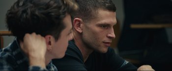 Movie still from “120 BPM” (2017), directed by Robin Campillo – A person sitting in front of another person; Close Up shot, Over the shoulder angle