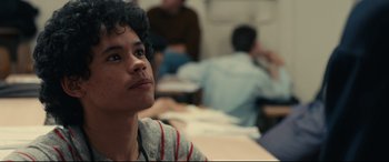 Movie still from “120 BPM” (2017), directed by Robin Campillo – A man sitting in front of a group of people; Close Up shot, Over the shoulder angle