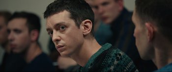Movie still from “120 BPM” (2017), directed by Robin Campillo – A person wearing a green sweater; Close Up shot, Over the shoulder angle