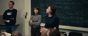 Movie still from “120 BPM” (2017), directed by Robin Campillo – Two women standing in front of a chalkboard; Medium shot, Over the shoulder angle