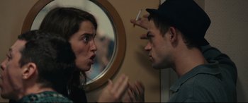 Movie still from “120 BPM” (2017), directed by Robin Campillo – A man and a woman talking in front of a round mirror; Close Up shot, Over the shoulder angle