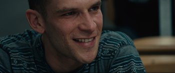 Movie still from “120 BPM” (2017), directed by Robin Campillo – A man smiling for the camera; Close Up shot, Low angle