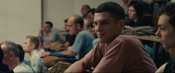 Movie still from “120 BPM” (2017), directed by Robin Campillo – A group of people sitting in a room; Medium shot, Over the shoulder angle