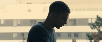 Movie still from “120 BPM” (2017), directed by Robin Campillo – A young man is standing in front of a window; Close Up shot, Low angle