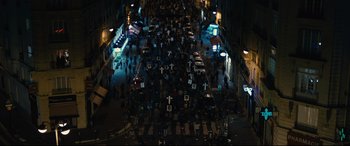Movie still from “120 BPM” (2017), directed by Robin Campillo – An aerial view of a crosswalk at night with crosses on it; Extreme Wide shot, High angle