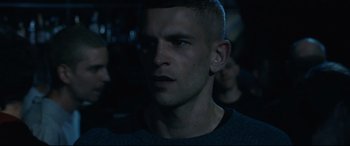 Movie still from “120 BPM” (2017), directed by Robin Campillo – A person wearing a black shirt; Close Up shot, Over the shoulder angle