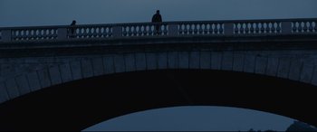 Movie still from “120 BPM” (2017), directed by Robin Campillo – A man sitting on a bridge looking at the sky at night; Extreme Wide shot, Low angle