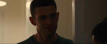 Movie still from “120 BPM” (2017), directed by Robin Campillo – A person wearing a green shirt; Close Up shot, Over the shoulder angle