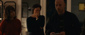 Movie still from “120 BPM” (2017), directed by Robin Campillo – A man and a woman standing next to each other in a room; Medium shot, Over the shoulder angle