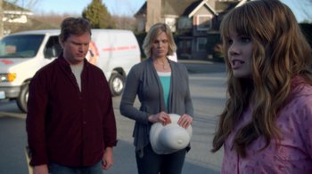 Movie still from “16 Wishes” (2010), directed by Peter DeLuise – Two people and a girl standing on the side of the street; Medium shot, Over the shoulder angle