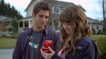 Movie still from “16 Wishes” (2010), directed by Peter DeLuise – A young man and a young woman looking at a gift; Close Up shot, Over the shoulder angle