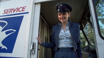 Movie still from “16 Wishes” (2010), directed by Peter DeLuise – A woman in a uniform standing in front of a truck; Medium shot, Low angle