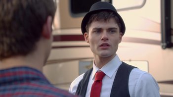 Movie still from “16 Wishes” (2010), directed by Peter DeLuise – A young man wearing a red tie and a hat; Close Up shot, Over the shoulder angle