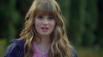 Movie still from “16 Wishes” (2010), directed by Peter DeLuise – A young girl with long blonde hair wearing a pink shirt; Close Up shot, Over the shoulder angle