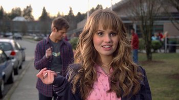 Movie still from “16 Wishes” (2010), directed by Peter DeLuise – A woman with long brown hair holding a cigarette in her hand; Close Up shot, Over the shoulder angle