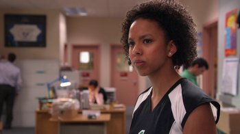 Movie still from “16 Wishes” (2010), directed by Peter DeLuise – A woman standing in front of a desk in an office; Close Up shot, Over the shoulder angle