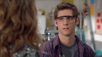 Movie still from “16 Wishes” (2010), directed by Peter DeLuise – A young man wearing glasses and a plaid shirt; Close Up shot, Over the shoulder angle