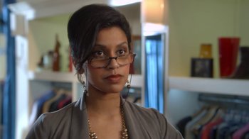 Movie still from “16 Wishes” (2010), directed by Peter DeLuise – A person wearing glasses and a necklace; Close Up shot, Over the shoulder angle