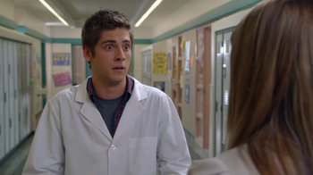Movie still from “16 Wishes” (2010), directed by Peter DeLuise – A man in a white lab coat talking to a woman; Close Up shot, Over the shoulder angle
