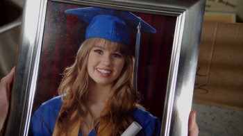Movie still from “16 Wishes” (2010), directed by Peter DeLuise – A woman in a graduation cap and gown holding a diploma; Extreme Close Up shot, High angle