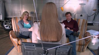 Movie still from “16 Wishes” (2010), directed by Peter DeLuise – A woman sitting in front of two other people; Medium shot, Over the shoulder angle