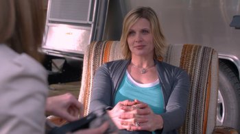 Movie still from “16 Wishes” (2010), directed by Peter DeLuise – A woman sitting in a chair holding a cell phone; Close Up shot, Over the shoulder angle