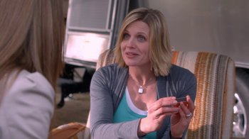 Movie still from “16 Wishes” (2010), directed by Peter DeLuise – A woman sitting on a chair holding a cell phone; Close Up shot, Over the shoulder angle