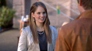 Movie still from “16 Wishes” (2010), directed by Peter DeLuise – A beautiful young lady standing next to a man; Close Up shot, Over the shoulder angle