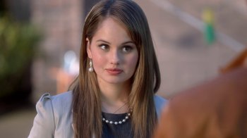 Movie still from “16 Wishes” (2010), directed by Peter DeLuise – A beautiful young lady with long brown hair wearing a necklace; Close Up shot, Over the shoulder angle