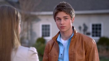 Movie still from “16 Wishes” (2010), directed by Peter DeLuise – A young man in a brown leather jacket and blue shirt; Close Up shot, Over the shoulder angle