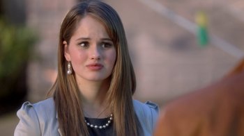 Movie still from “16 Wishes” (2010), directed by Peter DeLuise – A woman with long brown hair wearing a black top; Close Up shot, Over the shoulder angle