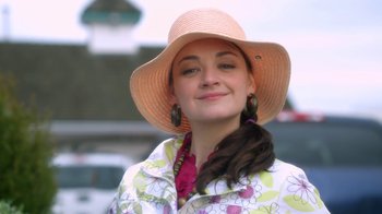 Movie still from “16 Wishes” (2010), directed by Peter DeLuise – A woman wearing a pink hat and a floral jacket; Close Up shot, Low angle