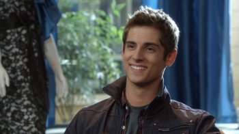 Movie still from “16 Wishes” (2010), directed by Peter DeLuise – A young man smiling for the camera in front of a tree; Close Up shot, Over the shoulder angle