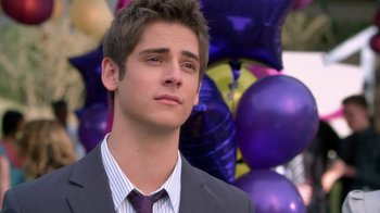 Movie still from “16 Wishes” (2010), directed by Peter DeLuise – A man in a suit and tie standing in front of a bunch of balloons; Close Up shot, Over the shoulder angle