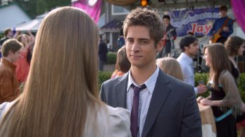 Movie still from “16 Wishes” (2010), directed by Peter DeLuise – A man in a suit and a tie talking to a woman in a suit; Close Up shot, Over the shoulder angle