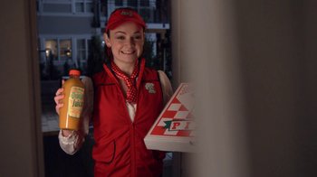 Movie still from “16 Wishes” (2010), directed by Peter DeLuise – A woman holding a bottle of juice and a box of pizza; Medium shot, Over the shoulder angle