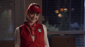 Movie still from “16 Wishes” (2010), directed by Peter DeLuise – A woman wearing a red hat and a red vest; Medium shot, Over the shoulder angle
