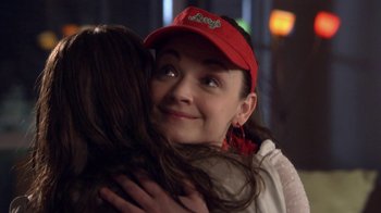 Movie still from “16 Wishes” (2010), directed by Peter DeLuise – A woman in a red hat is hugging another woman; Close Up shot, Over the shoulder angle