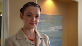 Movie still from “16 Wishes” (2010), directed by Peter DeLuise – A young woman wearing an orange bead necklace; Close Up shot, Over the shoulder angle