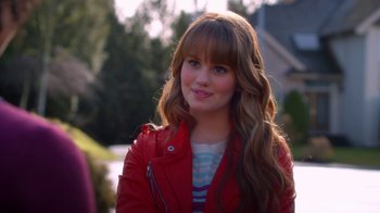Movie still from “16 Wishes” (2010), directed by Peter DeLuise – A woman in a red jacket is smiling for the camera; Close Up shot, Over the shoulder angle