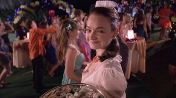 Movie still from “16 Wishes” (2010), directed by Peter DeLuise – A young girl holding a tray of food at an event; Close Up shot, Over the shoulder angle