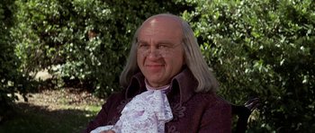 Movie still from “1776” (1972), directed by Peter H. Hunt – A bald man in a wig and glasses; Close Up shot, Low angle