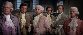 Movie still from “1776” (1972), directed by Peter H. Hunt – A group of men dressed in period clothing; Medium shot, Low angle
