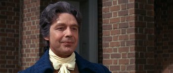 Movie still from “1776” (1972), directed by Peter H. Hunt – A person wearing a neck scarf; Close Up shot, Over the shoulder angle