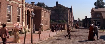 Movie still from “1776” (1972), directed by Peter H. Hunt – A group of people walking down a street; Extreme Wide shot, High angle