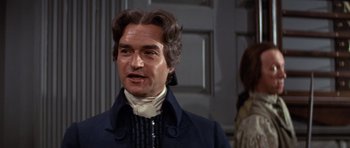 Movie still from “1776” (1972), directed by Peter H. Hunt – A person wearing a wig; Close Up shot, Over the shoulder angle