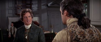 Movie still from “1776” (1972), directed by Peter H. Hunt – Two men are talking to each other in front of a building; Medium shot, Over the shoulder angle