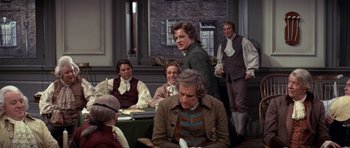Movie still from “1776” (1972), directed by Peter H. Hunt – A group of people sitting around a table; Medium shot, Over the shoulder angle