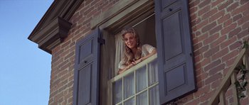 Movie still from “1776” (1972), directed by Peter H. Hunt – A young woman looking out of a window; Medium shot, Low angle