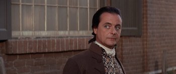 Movie still from “1776” (1972), directed by Peter H. Hunt – A person wearing a suit and tie; Close Up shot, Over the shoulder angle